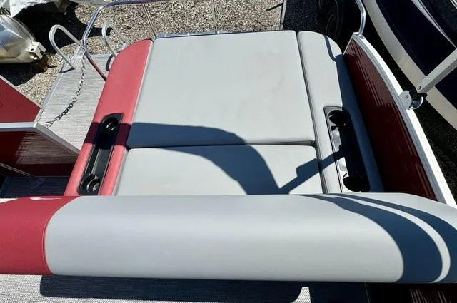 Slide: The Image of 2024 Bennington 20 SSB boat seating area with red and gray upholstery. - 17