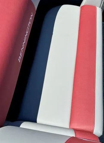 Slide: The Image of 2024 Bennington 20 SSB boat seat with red, white, and blue upholstery. - 19