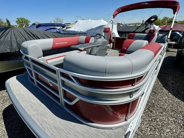 Slide: The Image of 2024 Bennington 20 SSB pontoon boat with red and gray seating. - 2