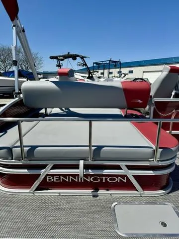 Slide: The Image of 2024 Bennington 20 SSB pontoon boat with red and gray seating. - 21