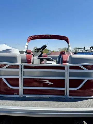 Slide: The Image of 2024 Bennington 20 SSB pontoon boat with red and white seating. - 3