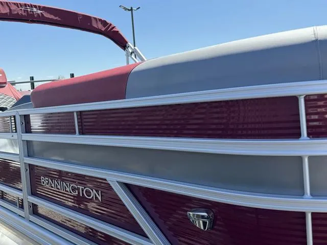 Slide: The Image of 2024 Bennington 20 SSB pontoon boat with maroon and gray exterior. - 5
