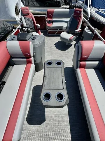 Slide: The Image of 2024 Bennington 20 SSB pontoon boat interior with red and gray seating. - 6