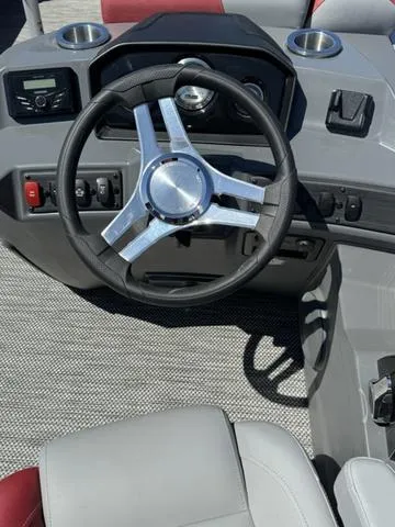 Slide: The Image of 2024 Bennington 20 SSB boat dashboard with steering wheel and controls. - 7