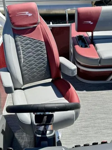 Slide: The Image of 2024 Bennington 20 SSB boat interior with red and gray captain's chair. - 8