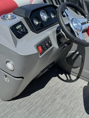 Slide: The Image of 2024 Bennington 20 SSB boat dashboard with steering wheel and control panel. - 9