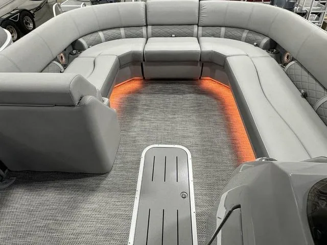 Slide: The Image of 2024 Bennington 23 LSB pontoon boat covered in a warehouse. - 11