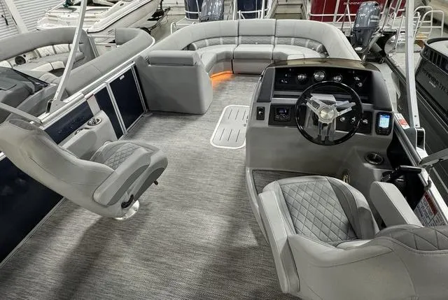 Slide: The Image of 2024 Bennington 23 LSB pontoon boat interior with plush seating and modern helm. - 12