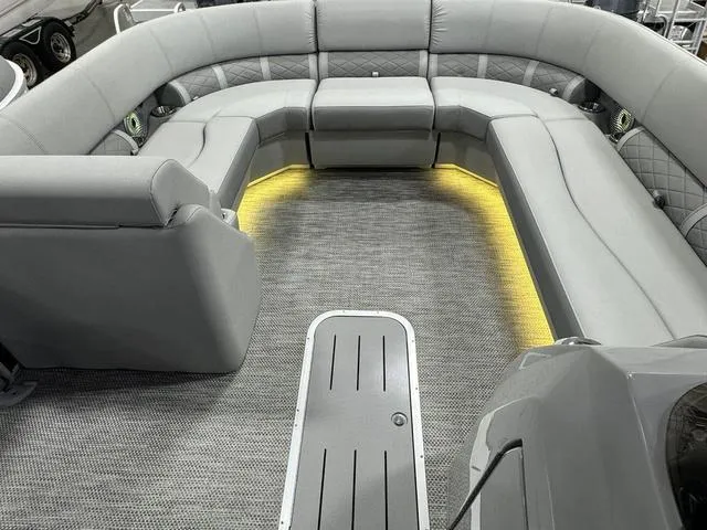 Slide: The Image of 2024 Bennington 23 LSB pontoon boat interior with gray seating and ambient lighting. - 13