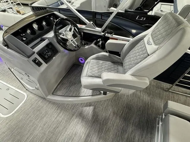 Slide: The Image of 2024 Bennington 23 LSB boat interior with modern helm and luxurious seating. - 16