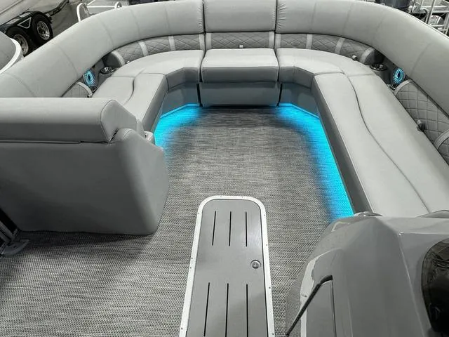 Slide: The Image of 2024 Bennington 23 LSB boat interior with gray seating and blue LED lighting. - 17