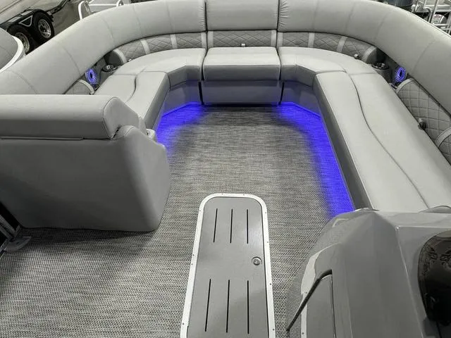 Slide: The Image of 2024 Bennington 23 LSB boat interior with gray seating and blue LED lighting. - 18