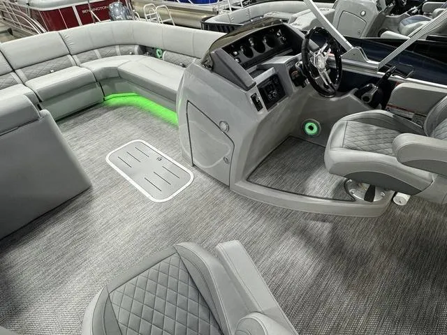 Slide: The Image of 2024 Bennington 23 LSB pontoon boat interior with modern seating and sleek dashboard. - 20