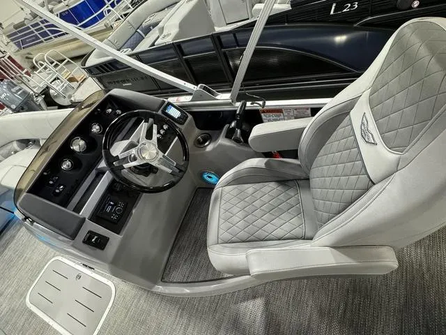 Slide: The Image of 2024 Bennington 23 LSB boat interior with modern steering and quilted seating. - 22