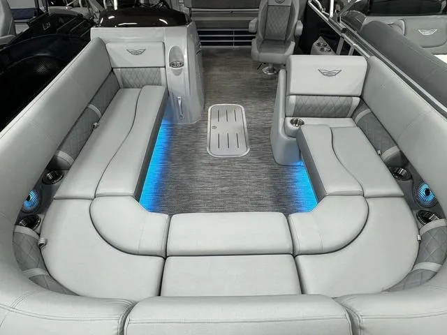 Slide: The Image of 2024 Bennington 23 LSB boat interior with gray seating and blue LED lighting. - 24