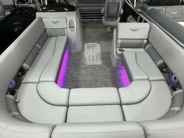 Slide: The Image of Luxurious interior of 2024 Bennington 23 LSB pontoon boat with ambient purple lighting. - 26