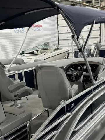 Slide: The Image of 2024 Bennington 23 LSB pontoon boat with canopy and modern interior design. - 30