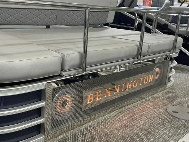 Slide: The Image of 2024 Bennington 23 LSB pontoon boat with cushioned seating and illuminated branding. - 34