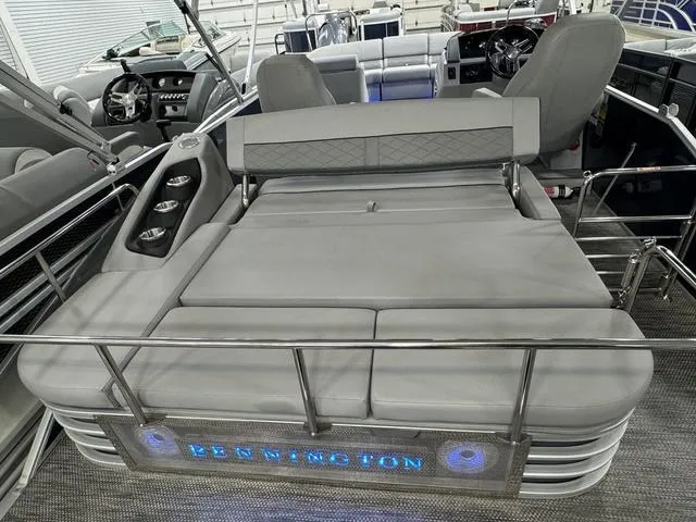 Slide: The Image of 2024 Bennington 23 LSB pontoon boat with luxurious seating and illuminated branding. - 39
