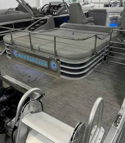 Slide: The Image of 2024 Bennington 23 LSB pontoon boat interior with seating and illuminated logo. - 48