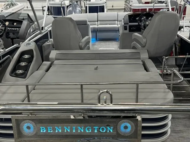 Slide: The Image of 2024 Bennington 23 LSB pontoon boat interior with plush seating and modern dashboard. - 49