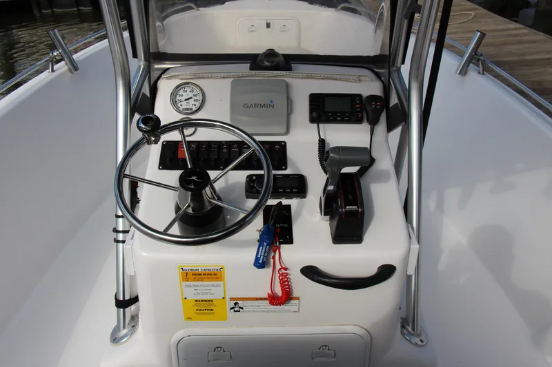 Slide: The Image of 2014 Pro-Line 21 CC boat console with Garmin GPS, steering wheel, and control panel. - 10