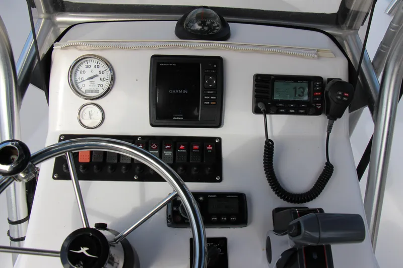 Slide: The Image of 2014 Pro-Line 21 CC boat dashboard with Garmin GPS, gauges, and controls. - 11