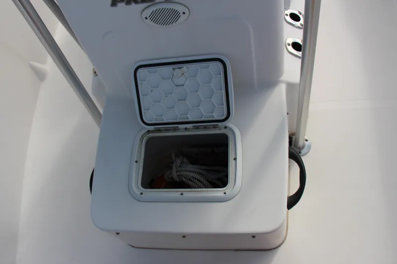 Slide: The Image of 2014 Pro-Line 21 CC boat storage compartment with open hatch. - 13