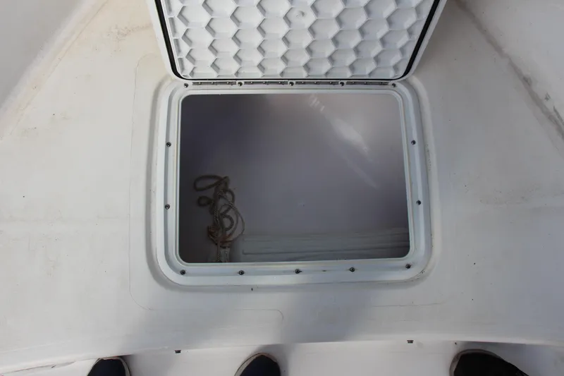 Slide: The Image of Open storage compartment on a 2014 Pro-Line 21 CC boat. - 14