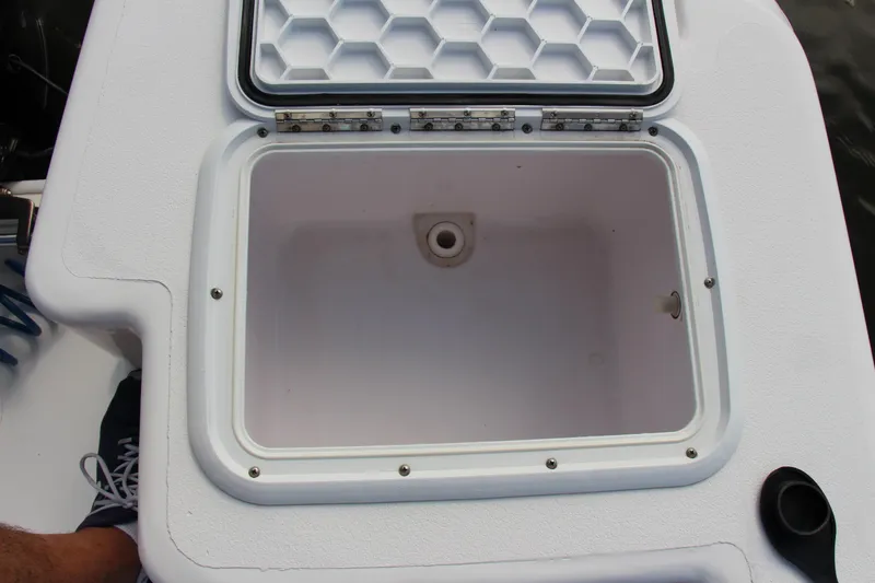 Slide: The Image of Open storage compartment on a 2014 Pro-Line 21 CC boat. - 18