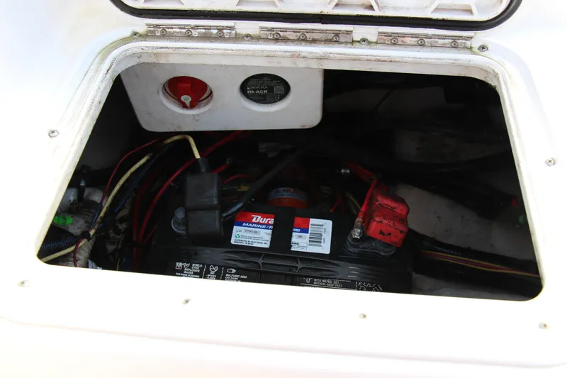 Slide: The Image of Battery compartment of a 2014 Pro-Line 21 CC boat with wiring and connections. - 19