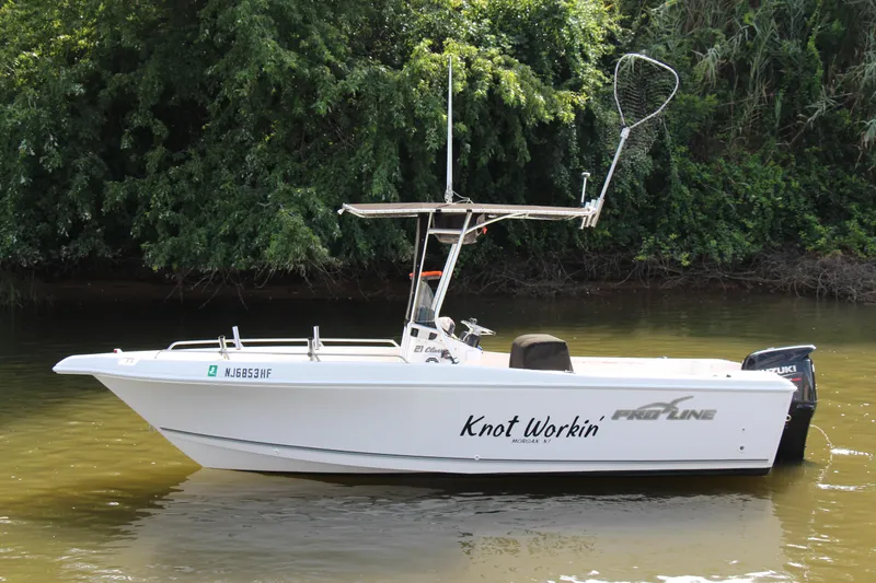 Slide: The Image of 2014 Pro-Line 21 CC boat named Knot Workin on a calm river. - 2