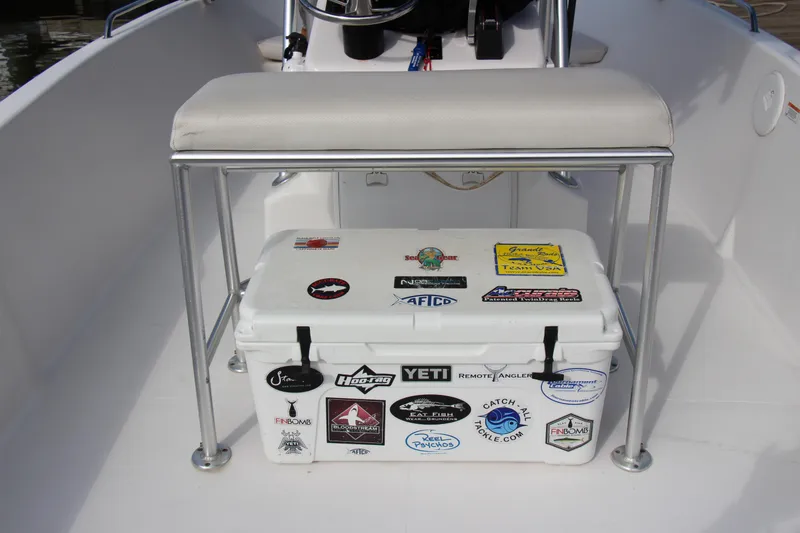 Slide: The Image of 2014 Pro-Line 21 CC boat with a sticker-covered cooler under the bench seat. - 20
