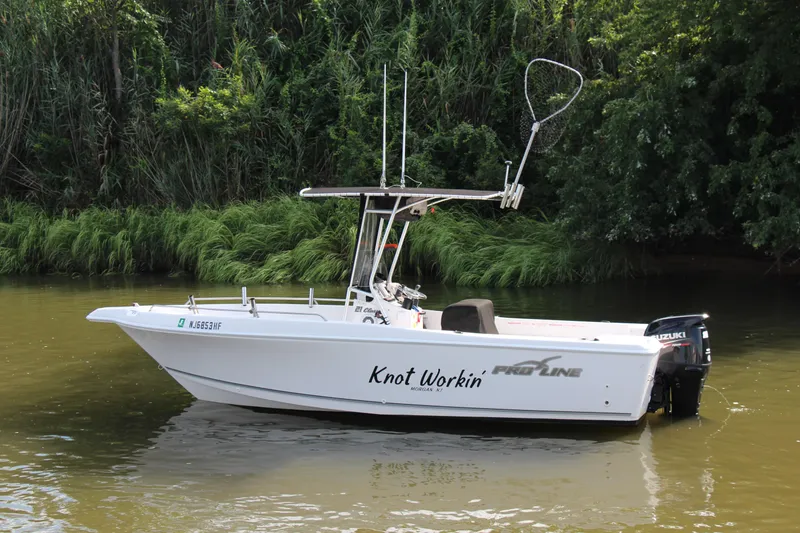 Slide: The Image of 2014 Pro-Line 21 CC boat named Knot Workin on a calm river. - 3