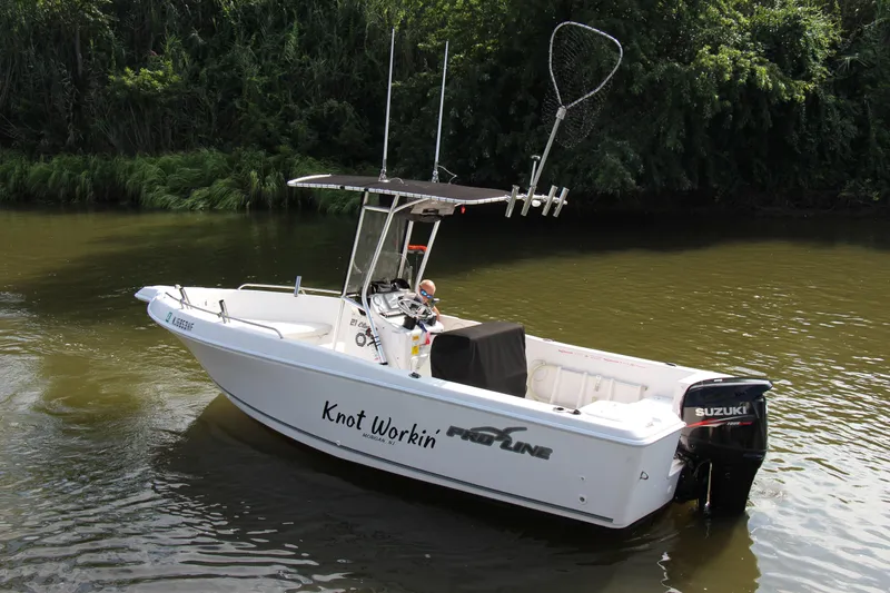 Slide: The Image of 2014 Pro-Line 21 CC boat on water with Suzuki outboard motor. - 4