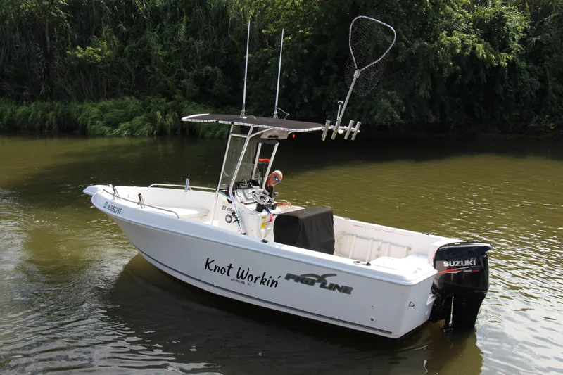 Slide: The Image of 2014 Pro-Line 21 CC boat on water with Suzuki outboard motor. - 5