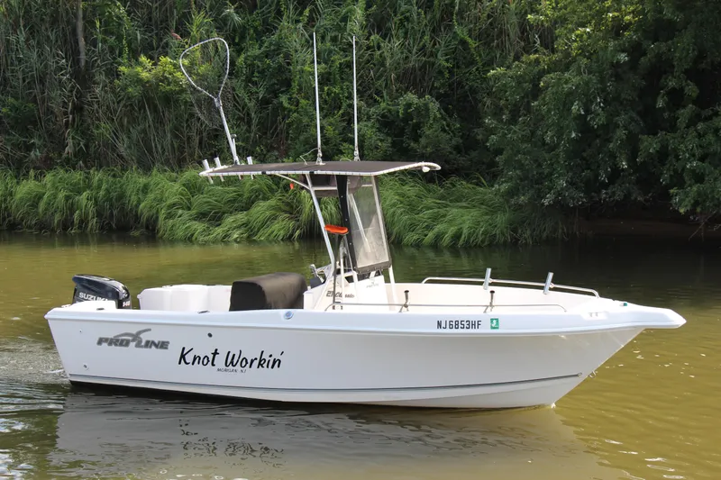 Slide: The Image of 2014 Pro-Line 21 CC boat named Knot Workin on a calm river. - 6