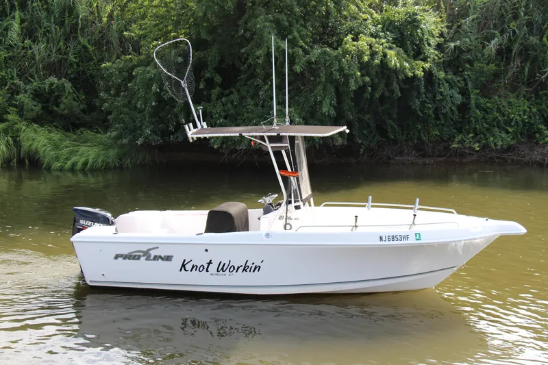 Slide: The Image of 2014 Pro-Line 21 CC boat named Knot Workin on calm water. - 7