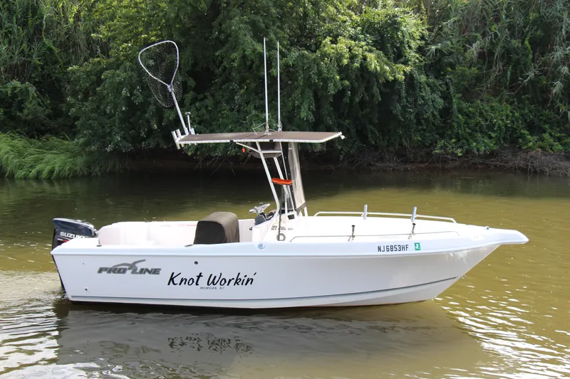 Slide: The Image of 2014 Pro-Line 21 CC boat named Knot Workin on a calm river. - 8
