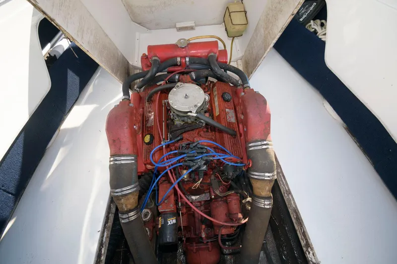 Slide: The Image of 1972 Chris-Craft Lancer 23 engine compartment with red engine and blue wires. - 13