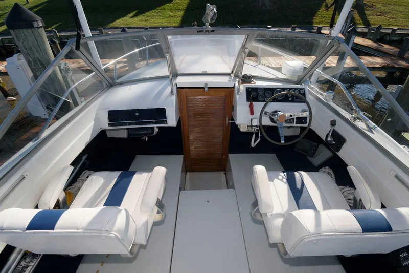 Slide: The Image of 1972 Chris-Craft Lancer 23 boat interior with white and blue seating. - 5