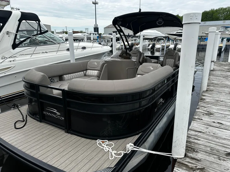 Slide: The Image of 2018 Bennington G25 pontoon boat docked at a marina. - 0