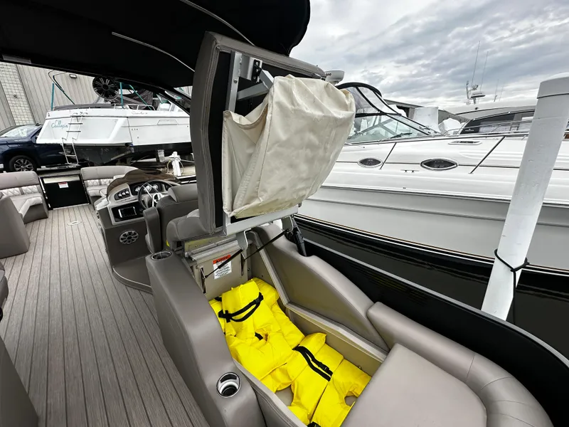 Slide: The Image of 2018 Bennington G25 boat interior with life jackets and seating. - 11