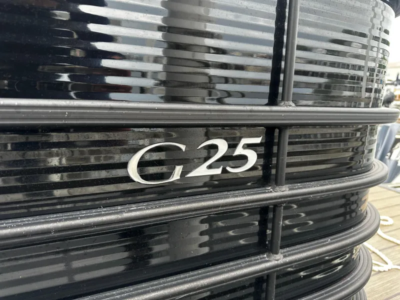 Slide: The Image of 2018 Bennington G25 boat model emblem on black exterior. - 16