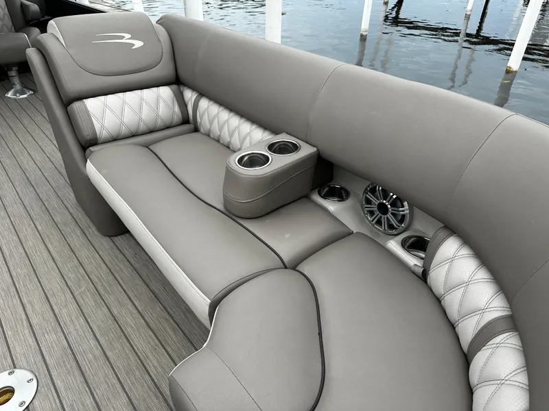Slide: The Image of Luxurious seating area on a 2018 Bennington G25 pontoon boat with cup holders and speakers. - 2