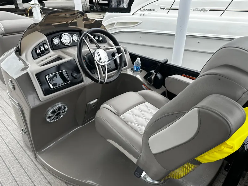 Slide: The Image of 2018 Bennington G25 boat cockpit with steering wheel and captain's chair. - 6