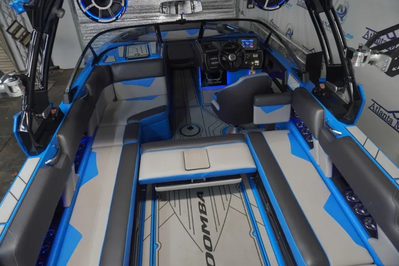 Slide: The Image of Interior of a 2021 Moomba Makai boat with blue and gray seating. - 11