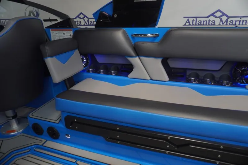 Slide: The Image of Interior of a 2021 Moomba Makai boat with blue and gray seating. - 13