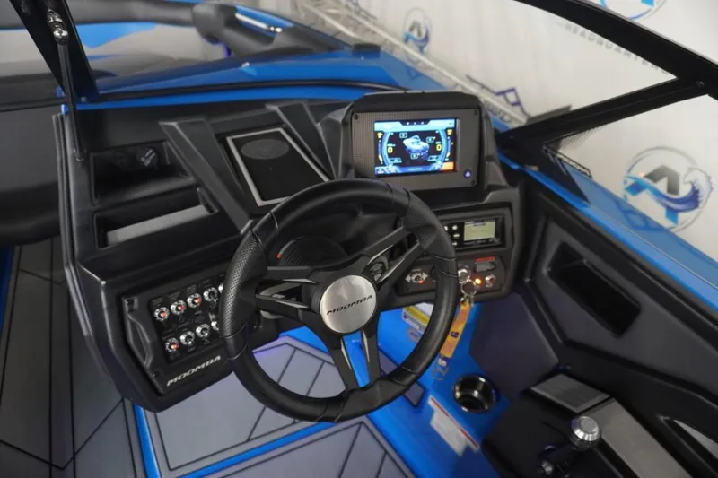 Slide: The Image of 2021 Moomba Makai interior with steering wheel and dashboard. - 16