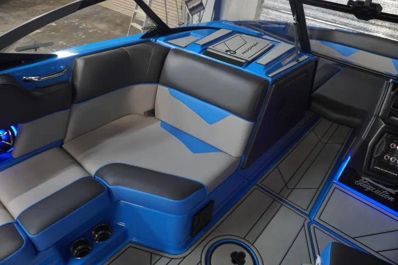 Slide: The Image of Interior of a 2021 Moomba Makai boat with blue and gray seating. - 17
